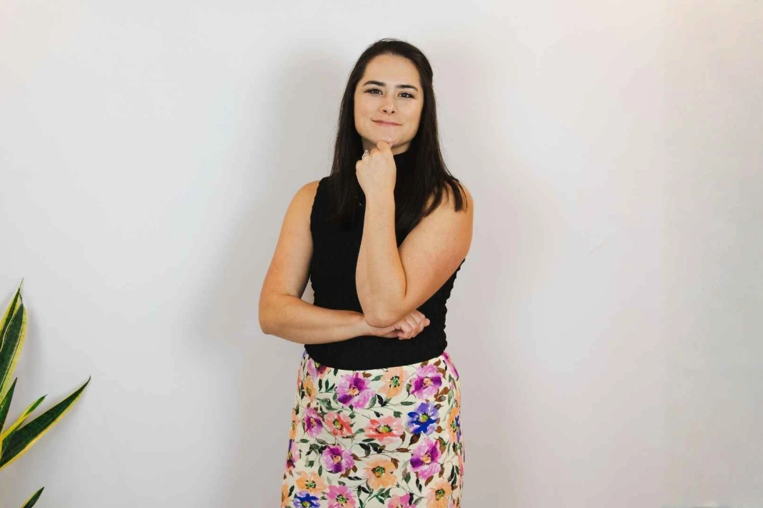 woman smiling with her hand on her chin